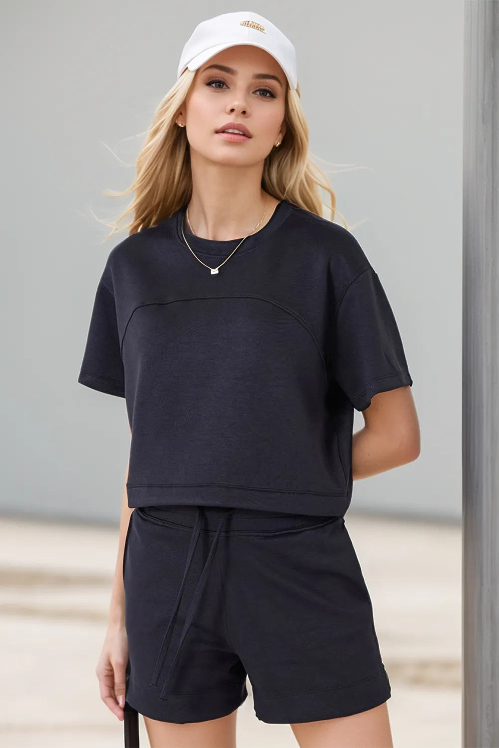 Black scuba round neck t-shirt with adjustable drawstring hem angled profile modern women's top