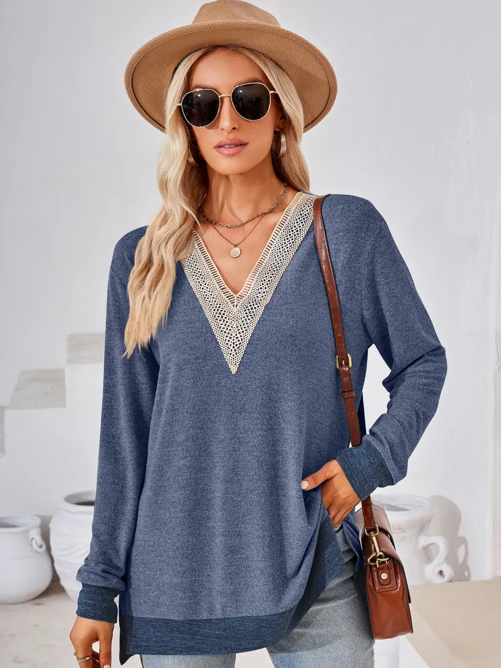 Back view of dusty blue crochet contrast long sleeve top with relaxed silhouette