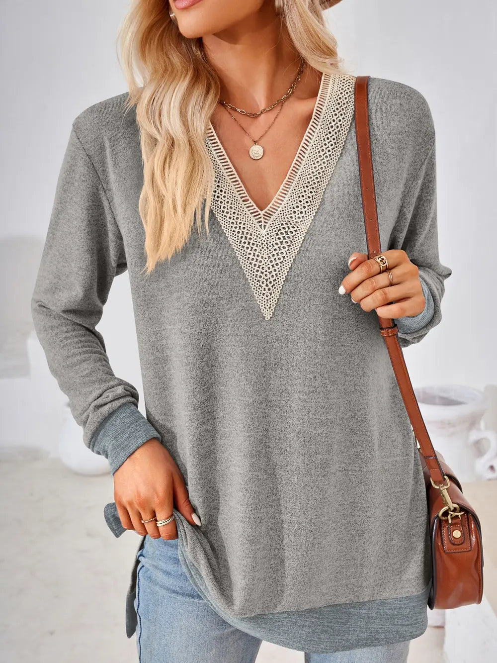 Light gray crochet contrast V neck long sleeve top with lace trim and side slit hem