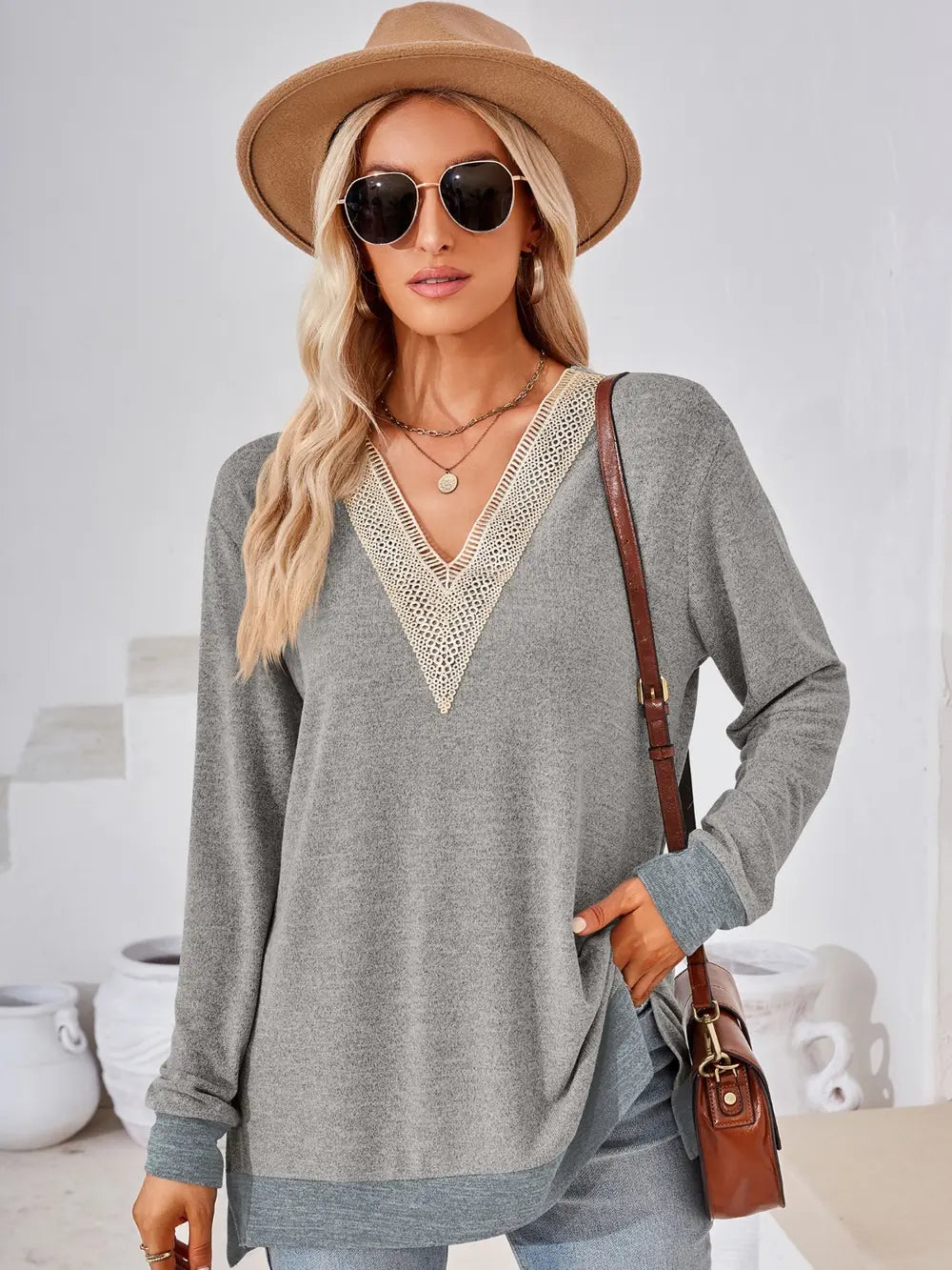 Light gray V neck long sleeve top featuring crochet accents and versatile casual styling
