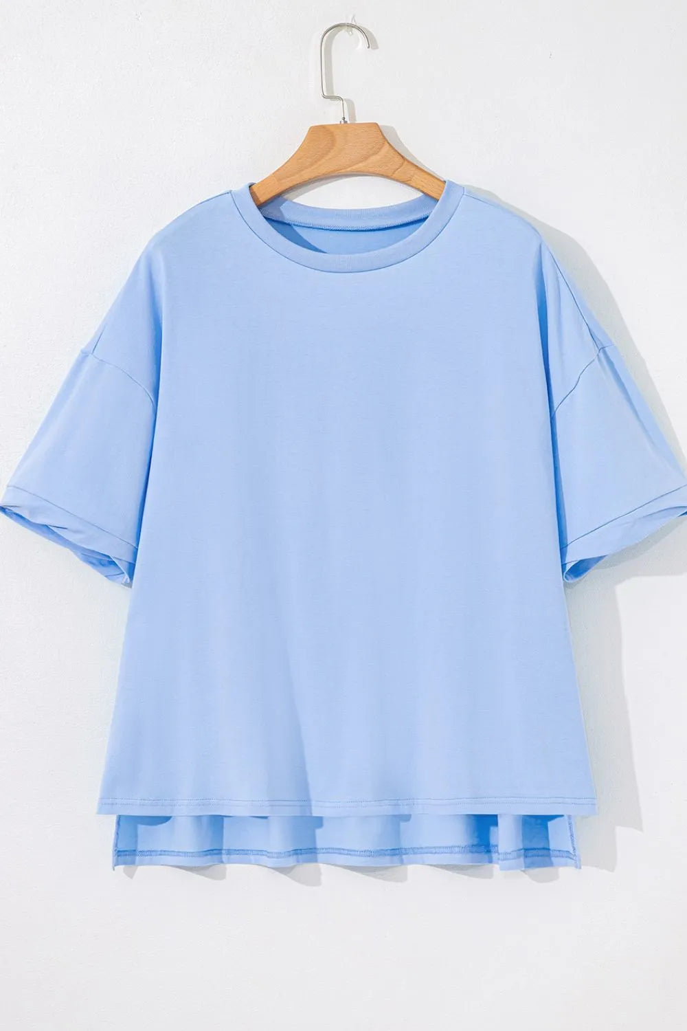 Light blue hi-low hem detail on loose half sleeve t-shirt showcasing modern casual styling