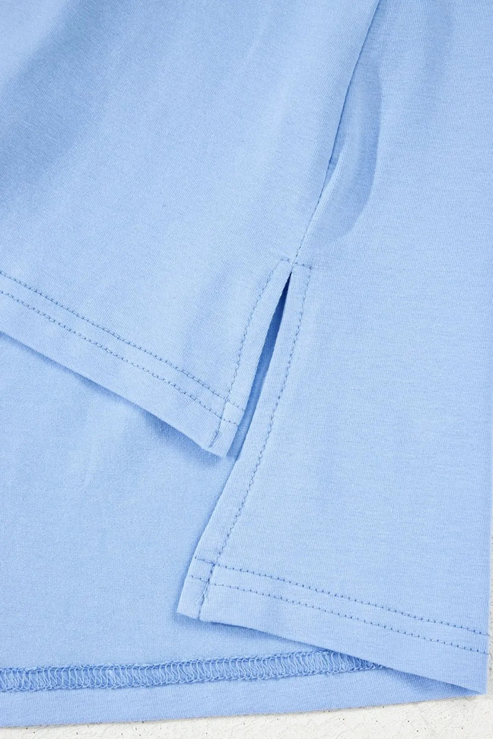 Close-up of light blue fabric with a focus on texture and pattern.