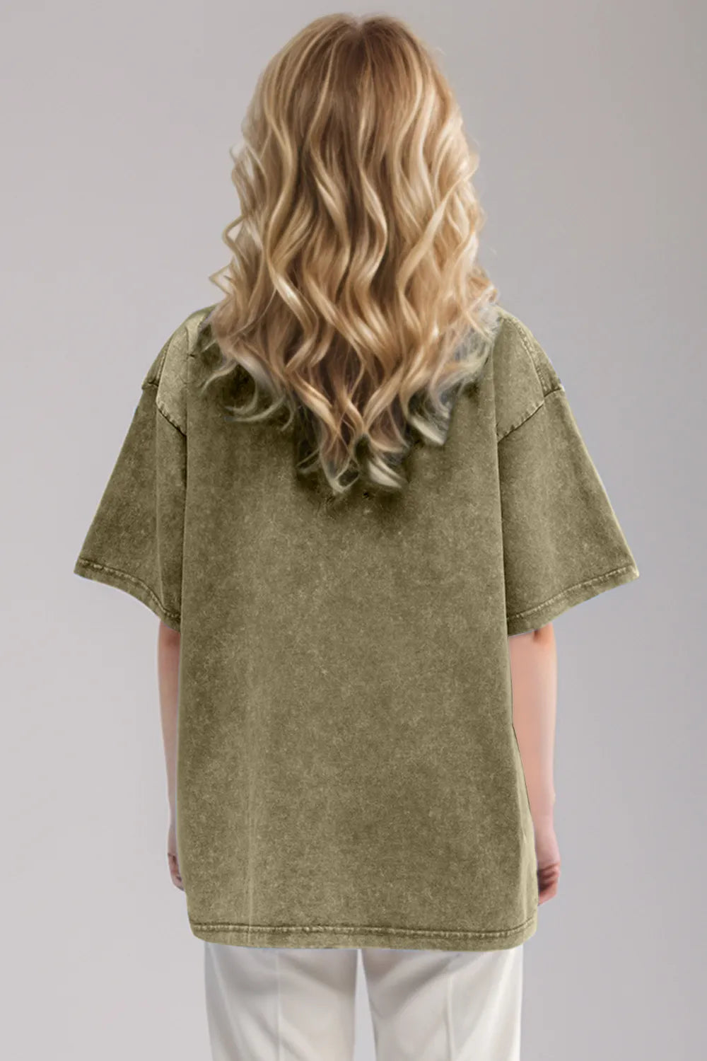 Person wearing an olive green oversized shirt with sheer sleeves on a gray background