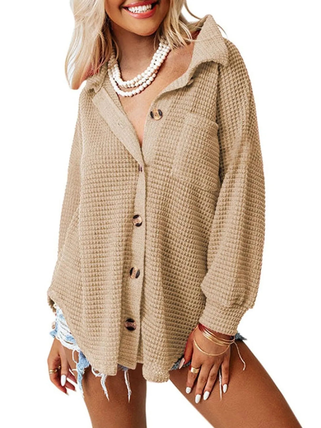 Woman wearing a beige cardigan on a white background