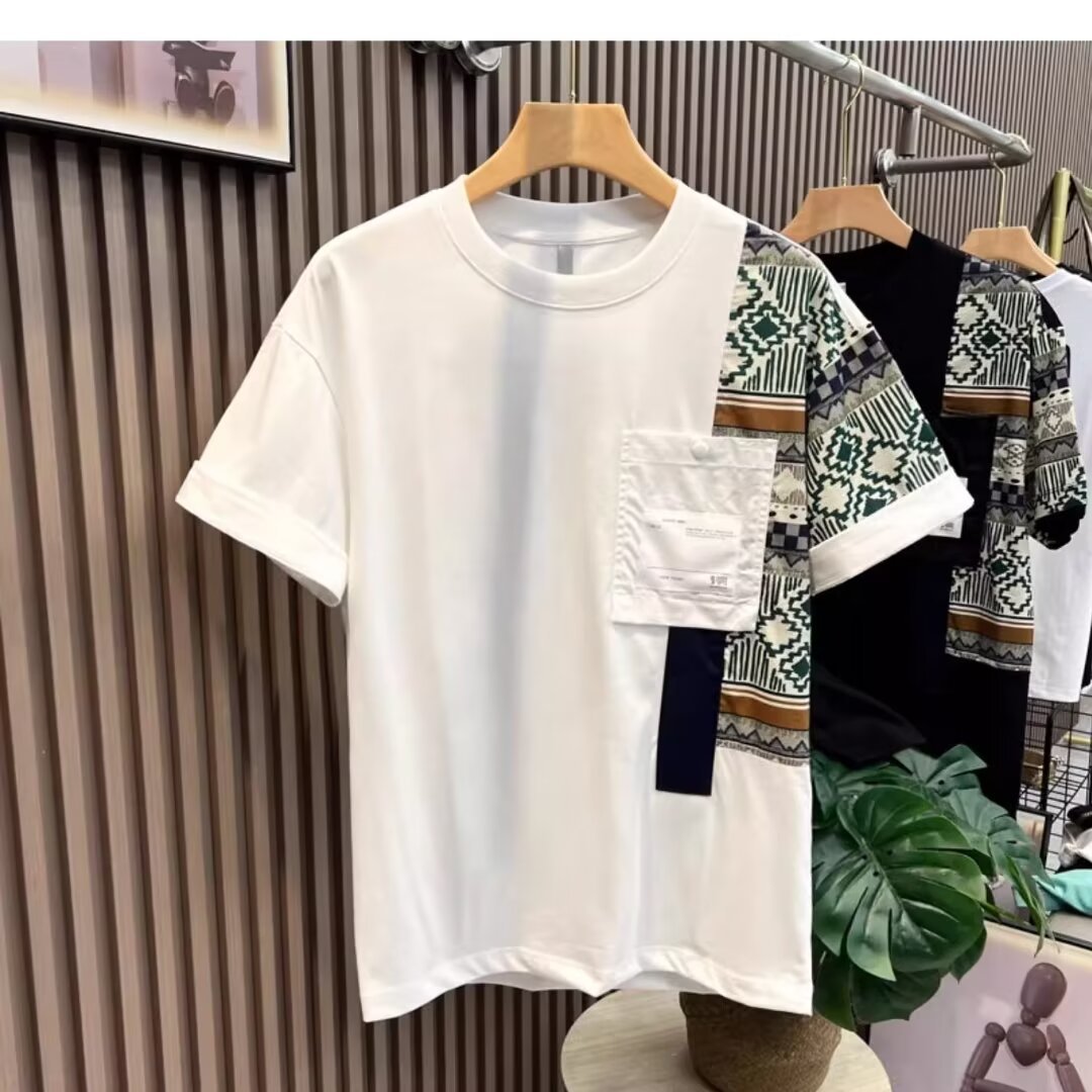 black-camouflage-patch-tee-closeup-pattern
Close-up of geometric camo panel and pocket detail on black slim fit T-shirt

White t-shirt with patterned sleeves on a hanger against a striped wall.