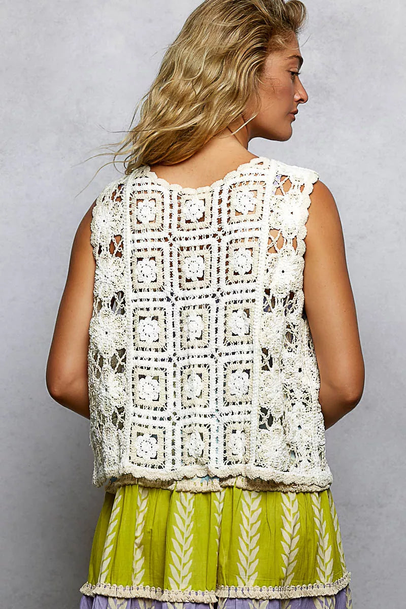 Casual outfit inspiration wearing cream crochet vest with drawstring over linen pants