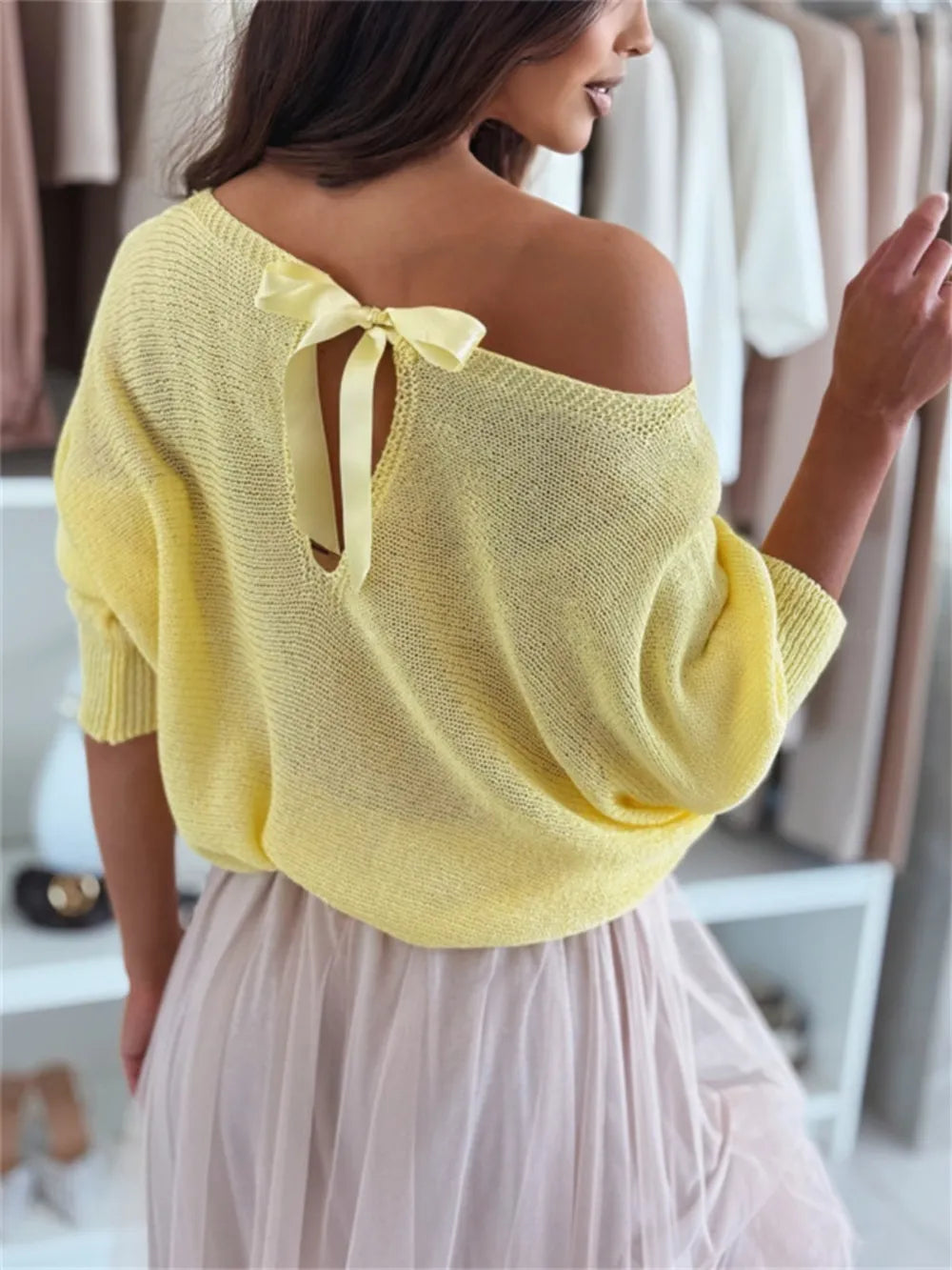 Woman wearing a yellow off-shoulder top with a blurred background
bow-back-off-shoulder-sweater-cream-front Cream bow back off-shoulder knit sweater with elegant tie detail, relaxed casual pullover