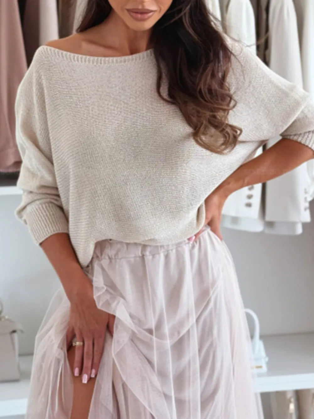 Woman wearing a beige sweater and light pink skirt in a neutral setting
Full romantic outfit featuring women’s bow back off-shoulder knit sweater with tulle skirt