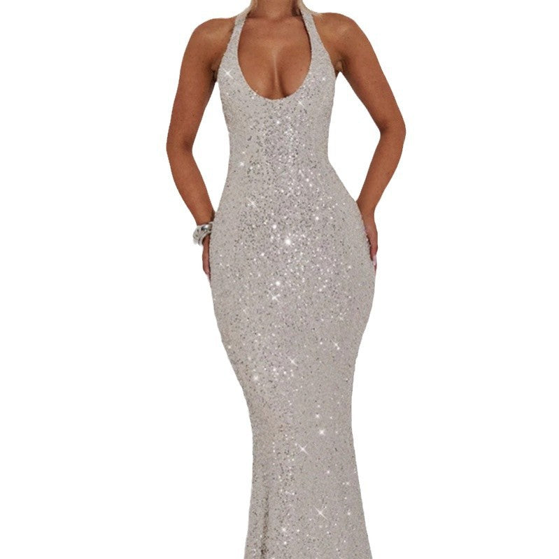 celeste-gold-sequin-maxi-backless-detail
Stunning back view of gold Celeste diamond sequin halter gown showing open back and high-waist sculpting

Silver sequin dress on a white background