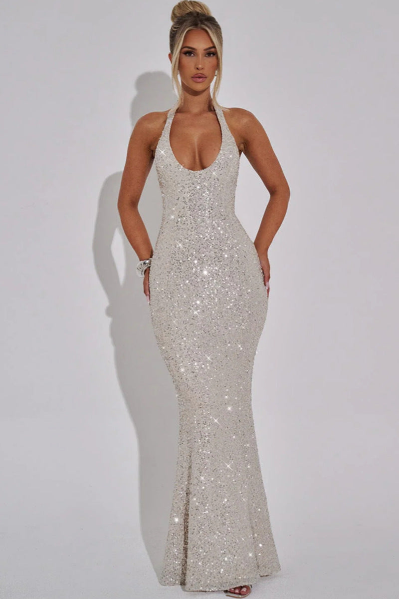 celeste-sequin-fabric-diamond-sparkle-macro
Macro shot of premium diamond-style sequin embellishment catching light on Celeste luxury gown

Woman wearing a sparkly silver evening gown against a plain background