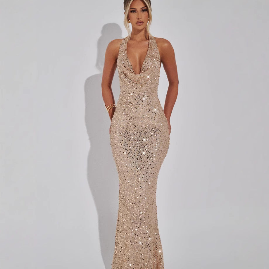 celeste-sequin-halter-gown-red-carpet-pose
Red-carpet moment: silver Celeste fully sequined halter maxi gown with dramatic lighting and pose

Woman wearing a sparkly gold evening gown against a plain background