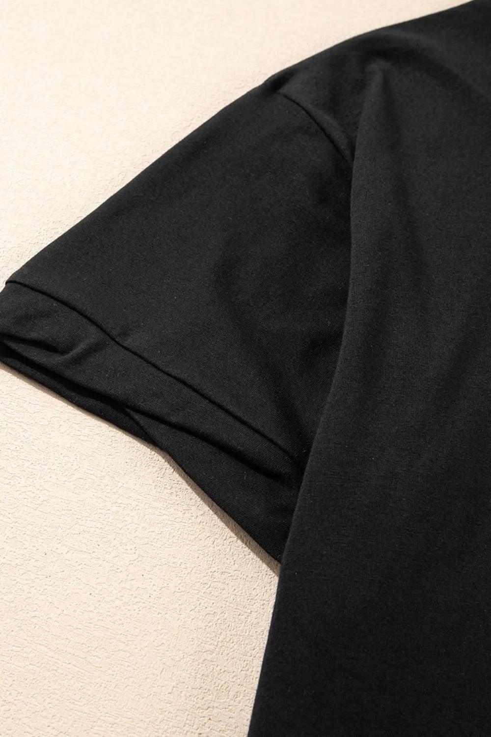Close-up of a black garment on a beige background