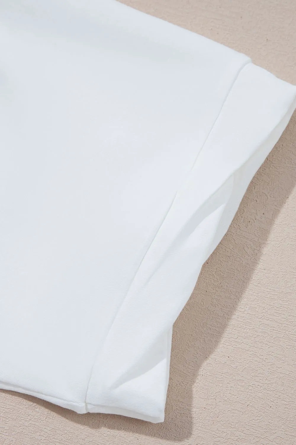 Close-up of a white fabric on a beige background