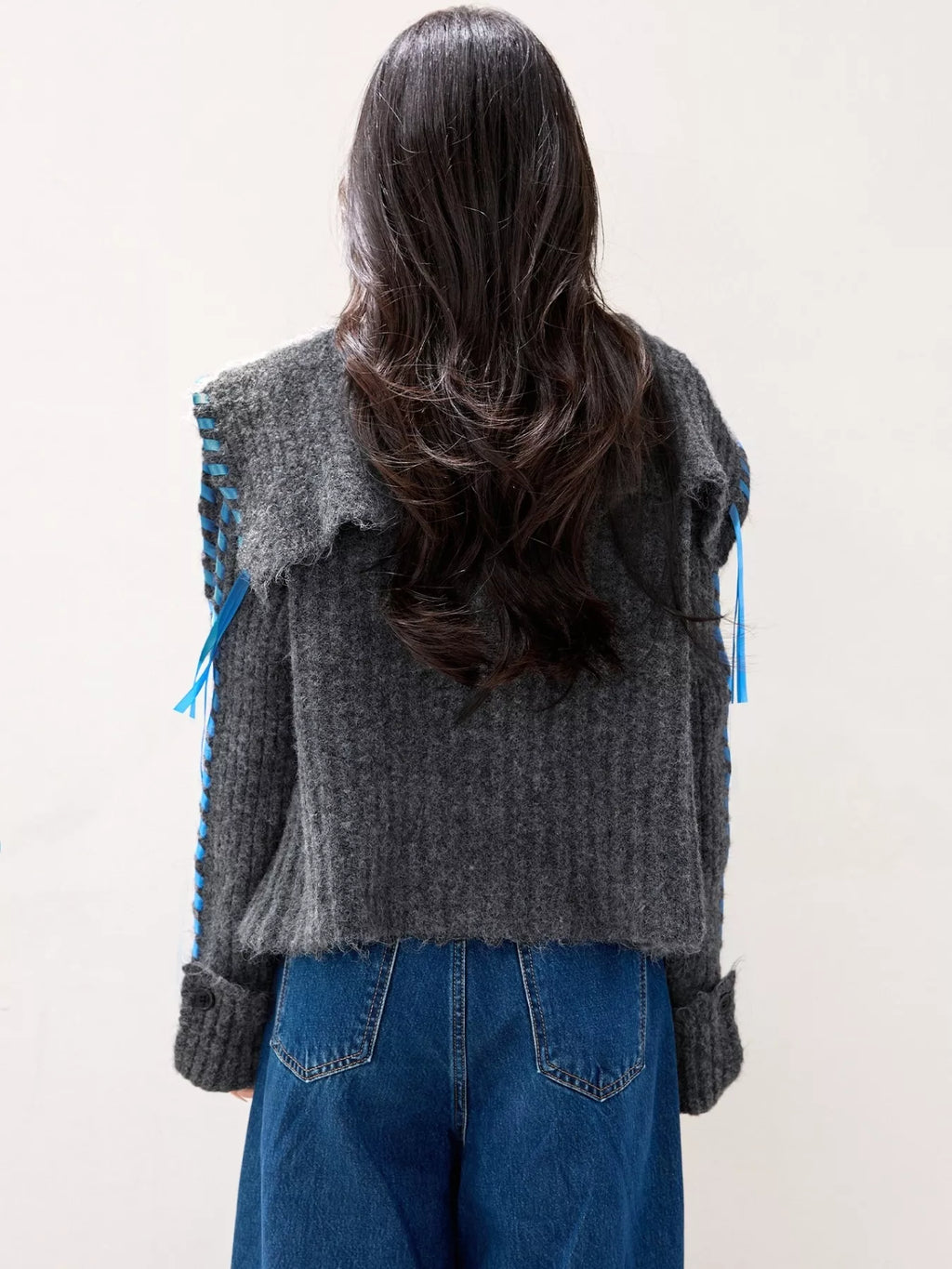 Woman wearing cozy oversized cable knit button cardigan, perfect for winter layering