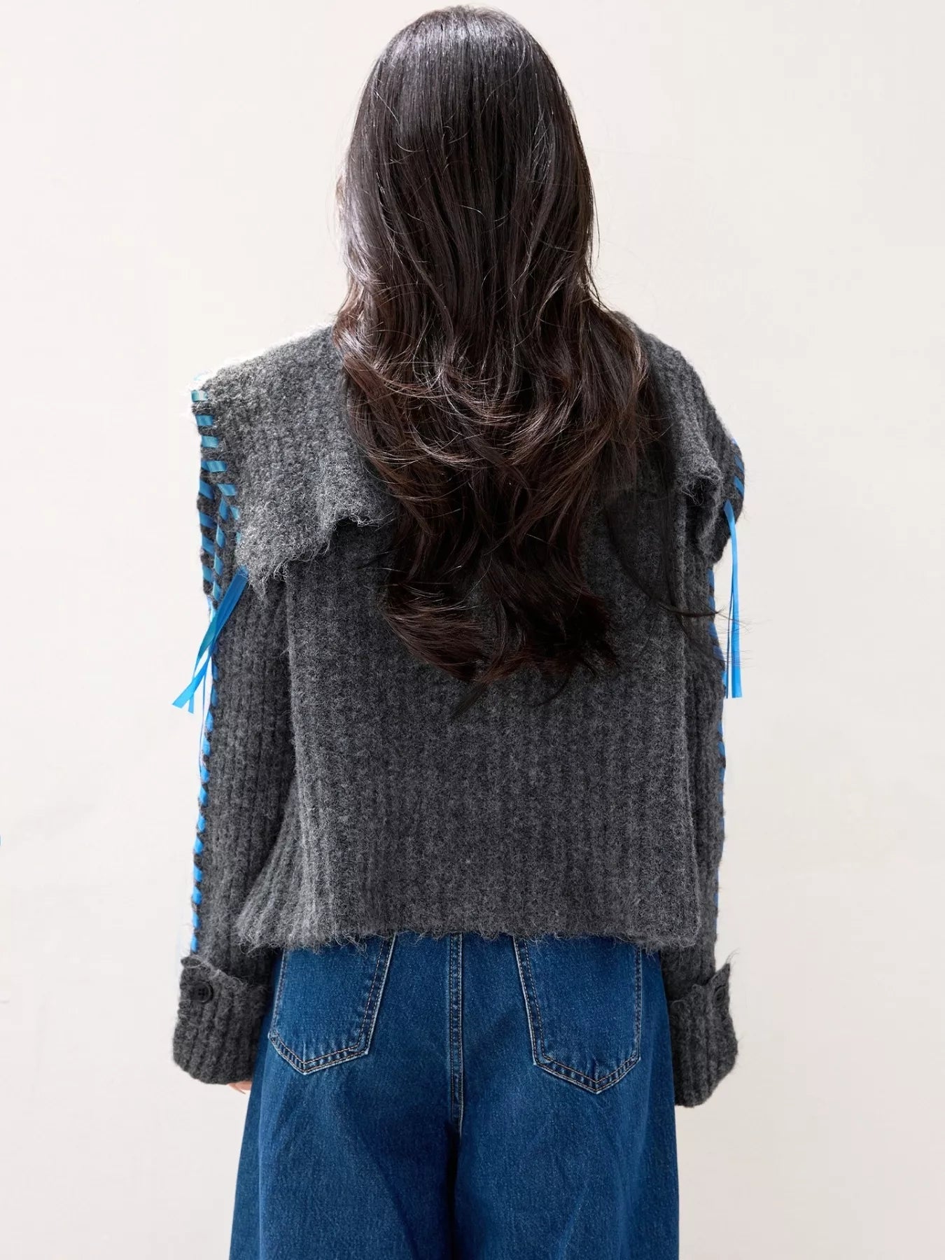 Woman wearing cozy oversized cable knit button cardigan, perfect for winter layering