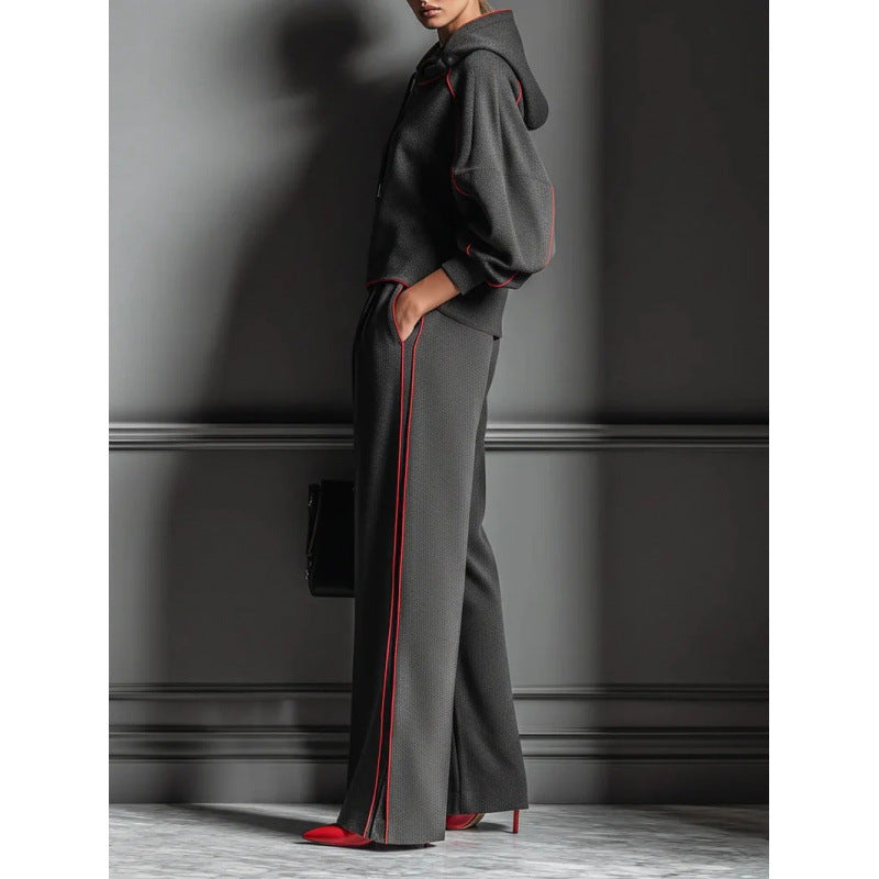 dark-grey-jogger-set-back-view
Back view of dark grey color block hoodie tracksuit showing relaxed fit and modern jogger silhouette

Person wearing a gray outfit with red accents against a dark wall.