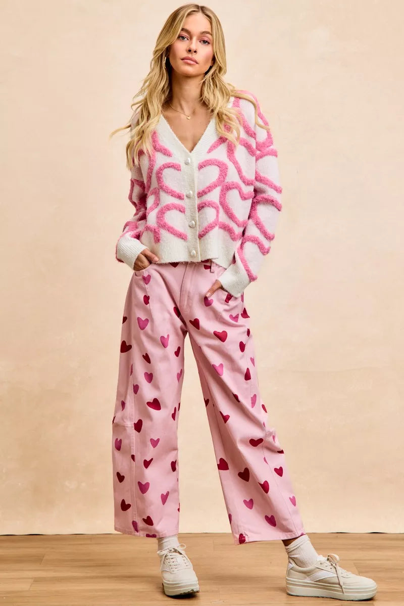 Valentine’s Day outfit with pink heart button cardigan and white skirt