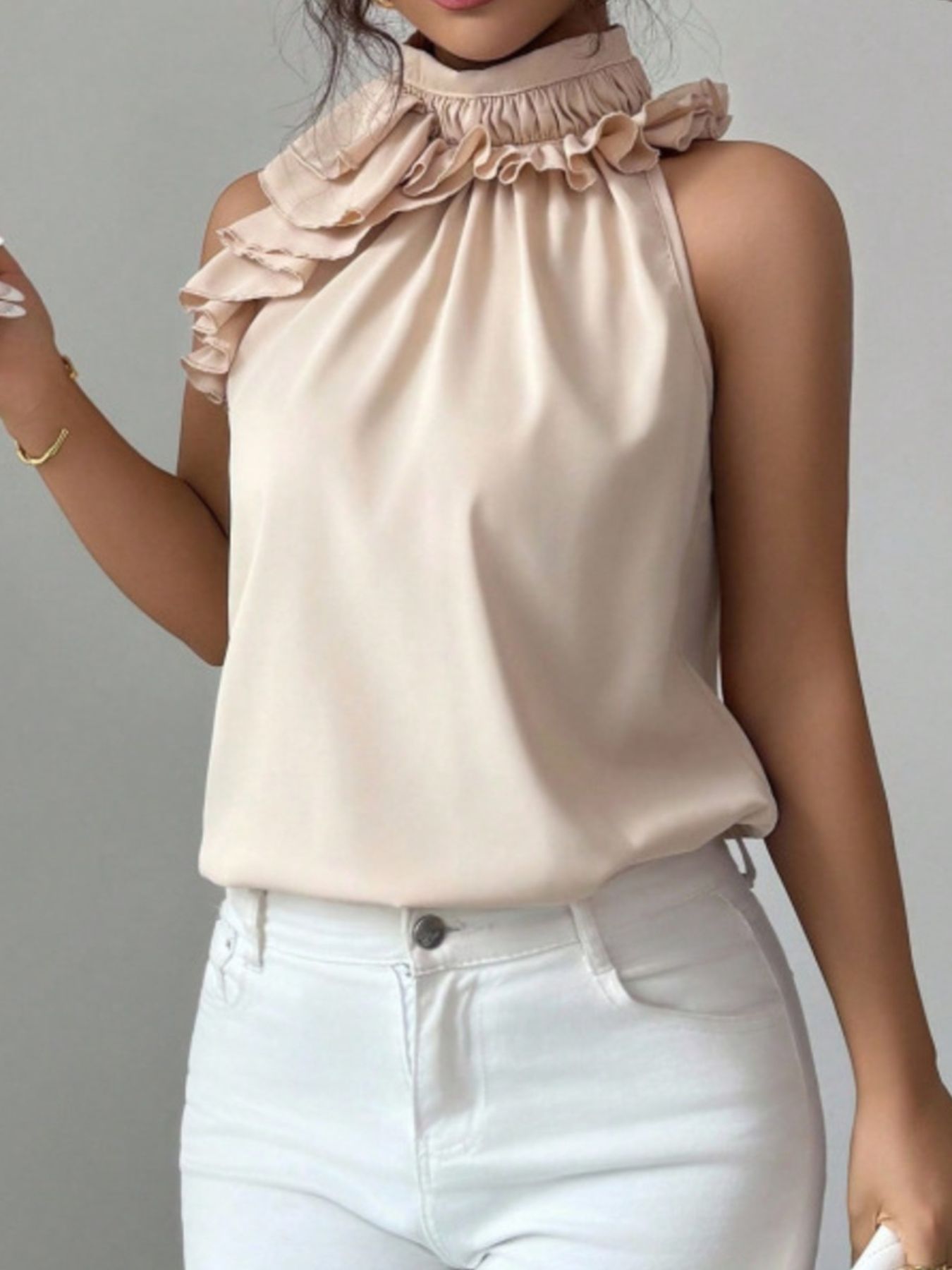 Front angle cream ruffle high neck sleeveless button top, showing neckline detail