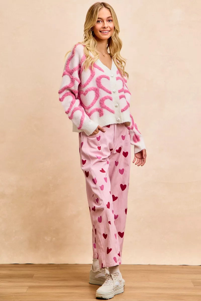 Back view of pink textured heart button V-neck cardigan, relaxed fit