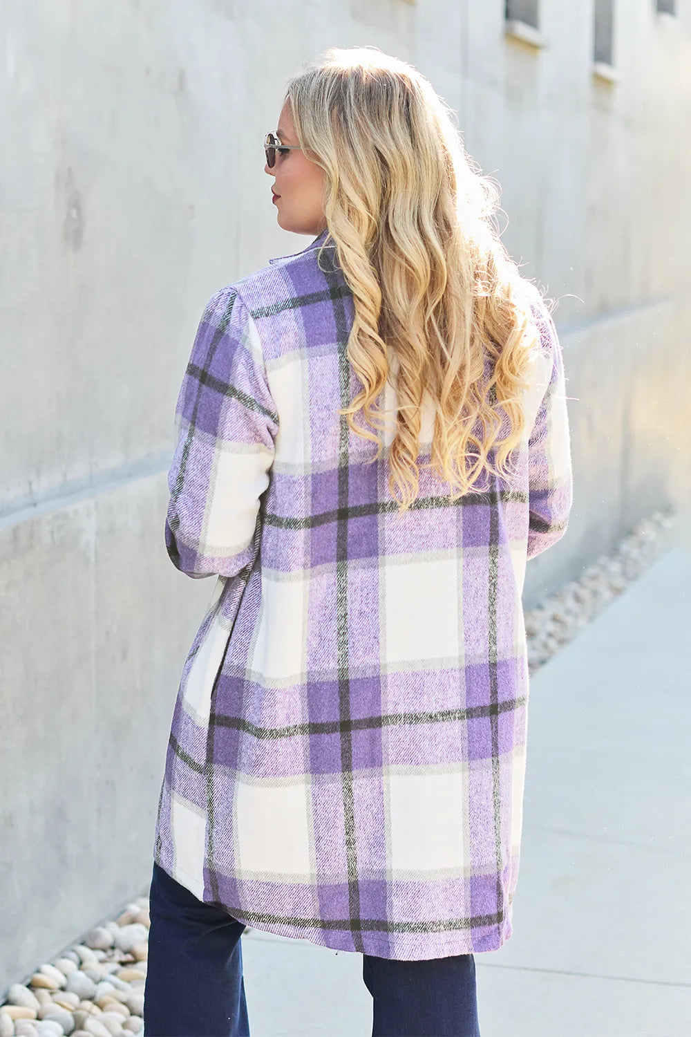 Full-body outdoor shot in pink plaid mid-length button coat with pockets