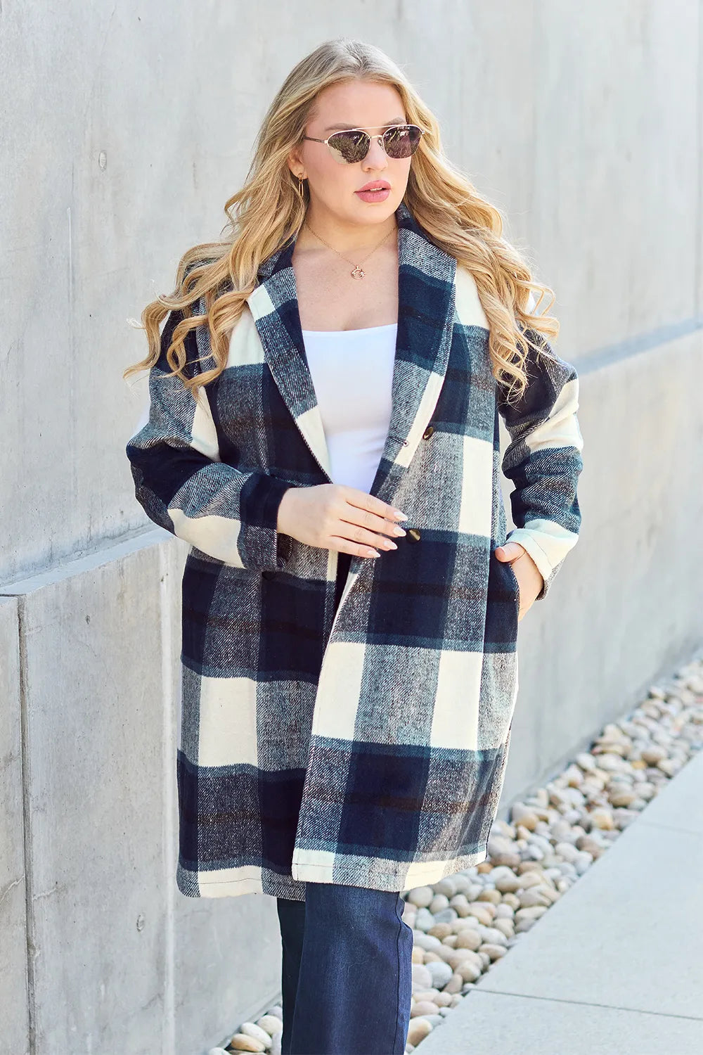 Bottom hem and mid-length cut detail of pink plaid coat