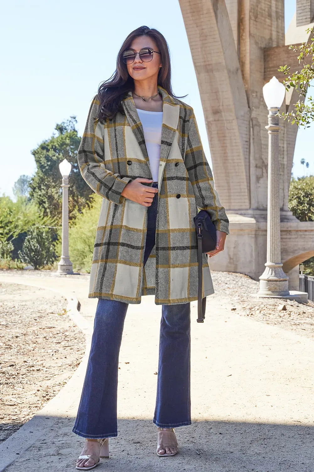 Golden hour photo of woman in pink plaid mid-length coat