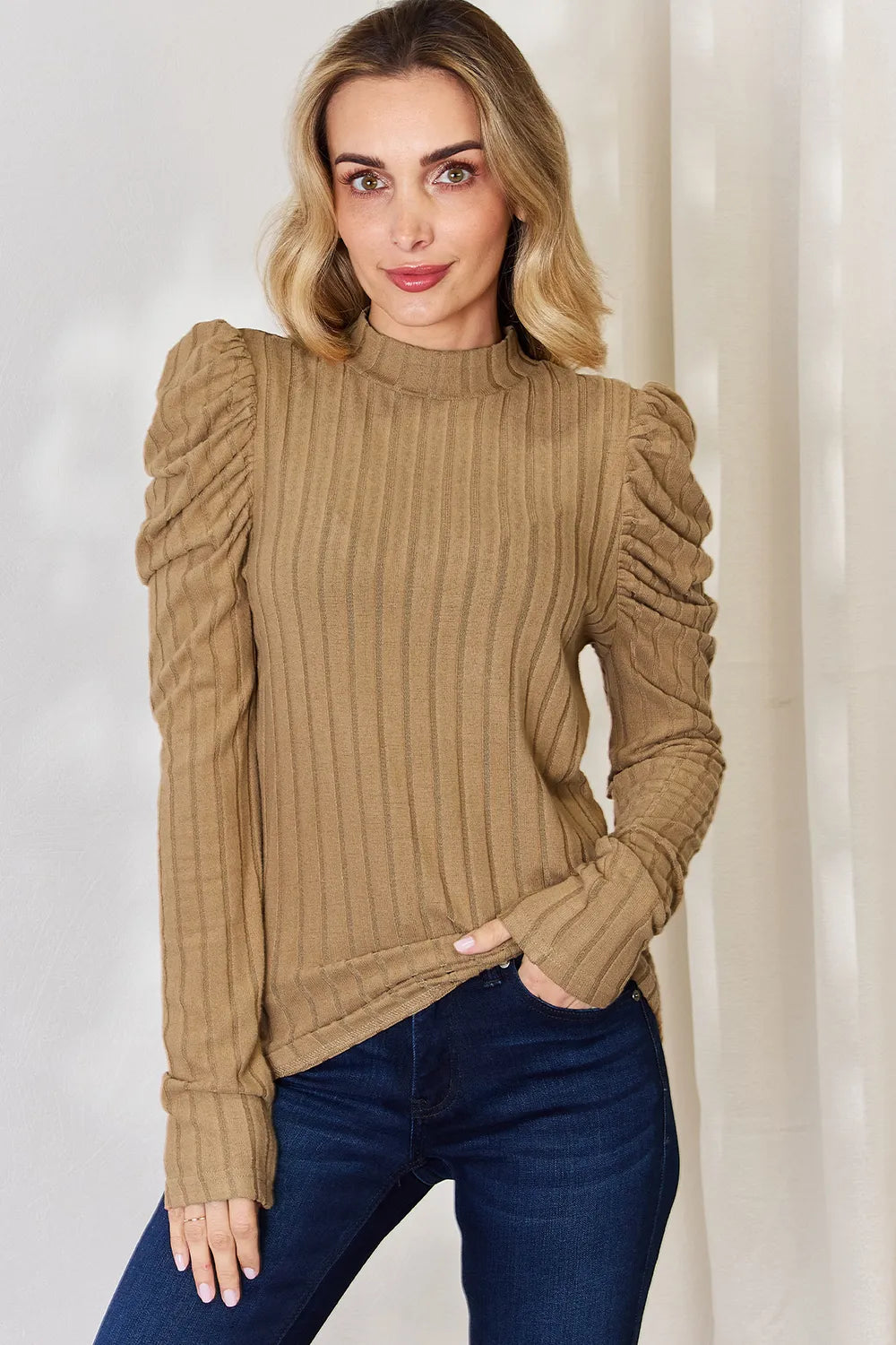 Bump-friendly stretch: ribbed mock neck top worn during pregnancy
