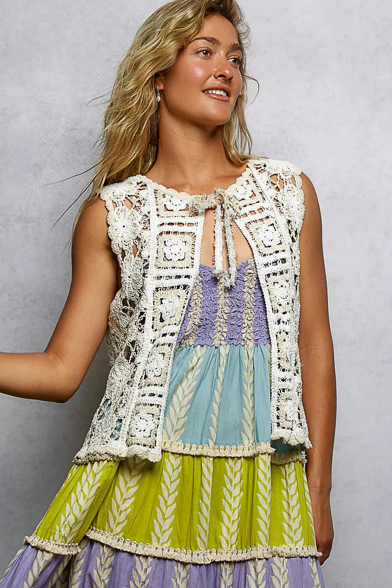 Side view of scalloped hem crochet vest showing relaxed one-size silhouette