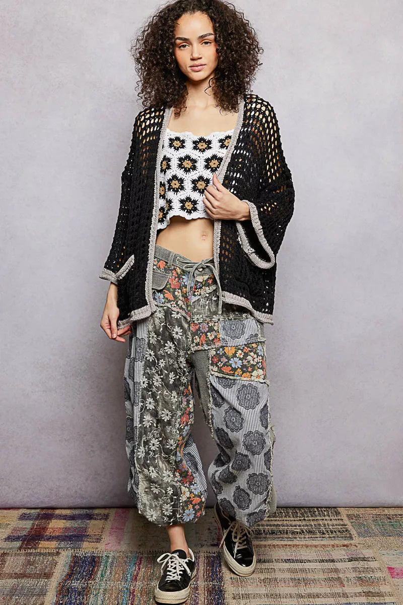 Woman wearing POL white openwork cardigan with contrast trim layered over tank top, perfect casual look