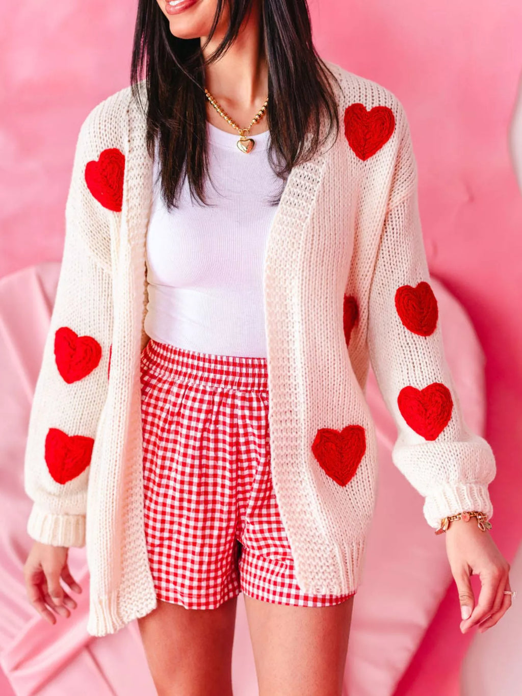 Close-up of romantic heart pattern knit on soft lightweight women’s cardigan, slightly stretchy